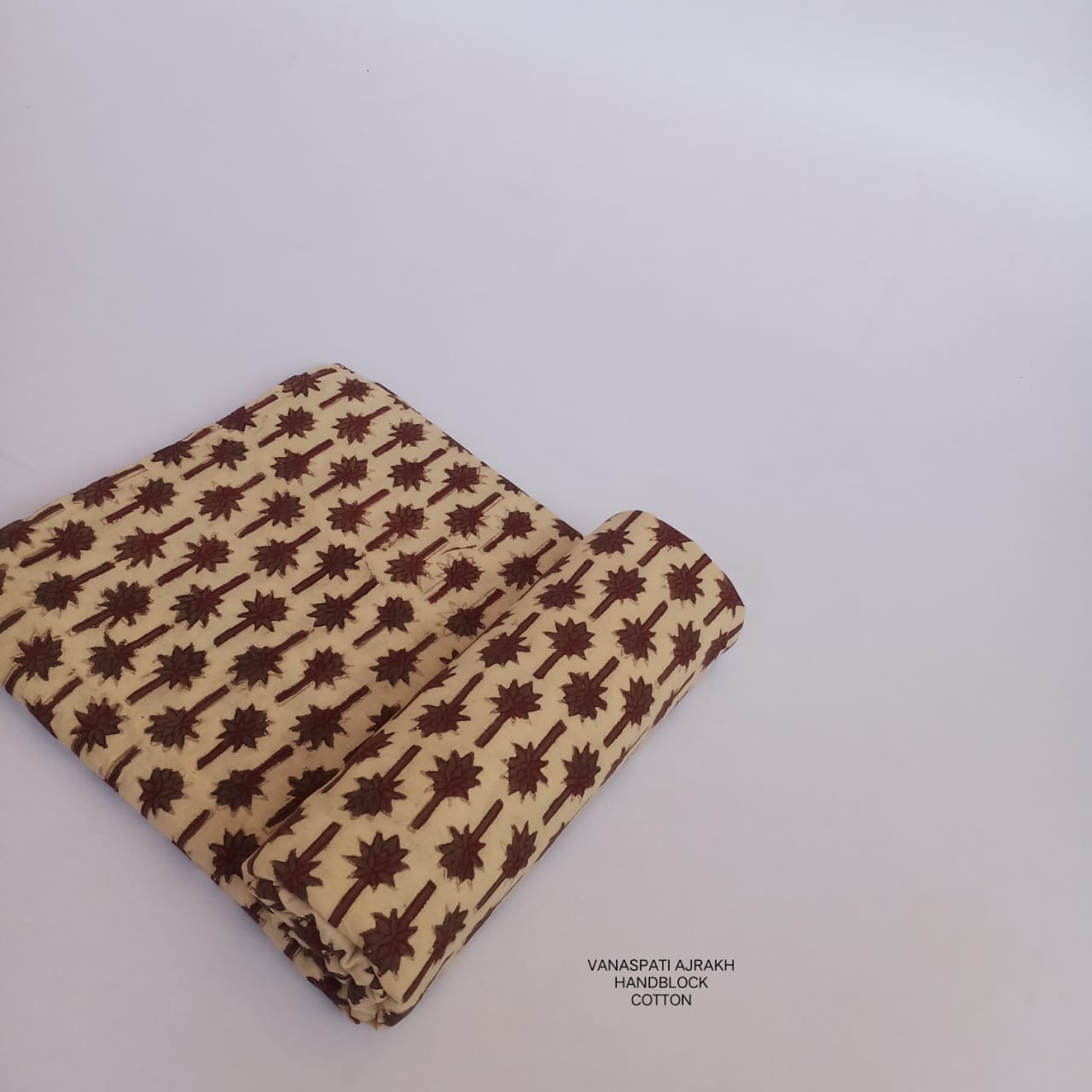 Cream and brown Vanaspati Bagru handblock printed cotton fabric, natural-dyed and ethically crafted for wholesale through Fabtexs.